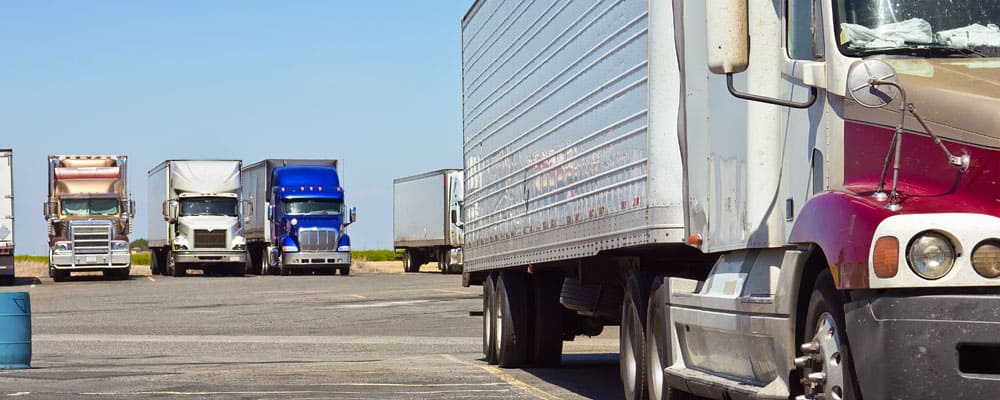 long haul trucks parked in parking lot