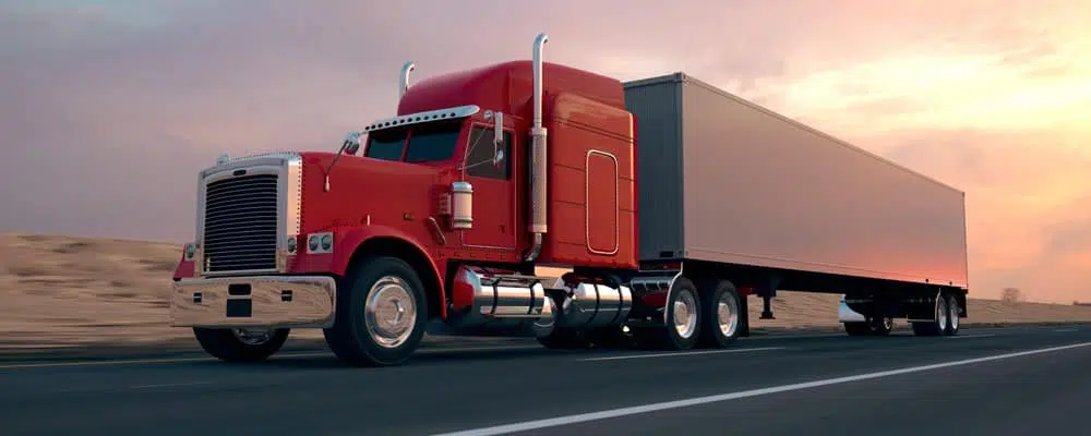red freight truck at sunset